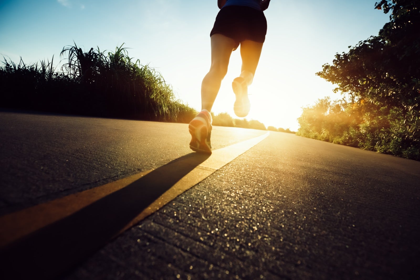 man running on the road at dawn